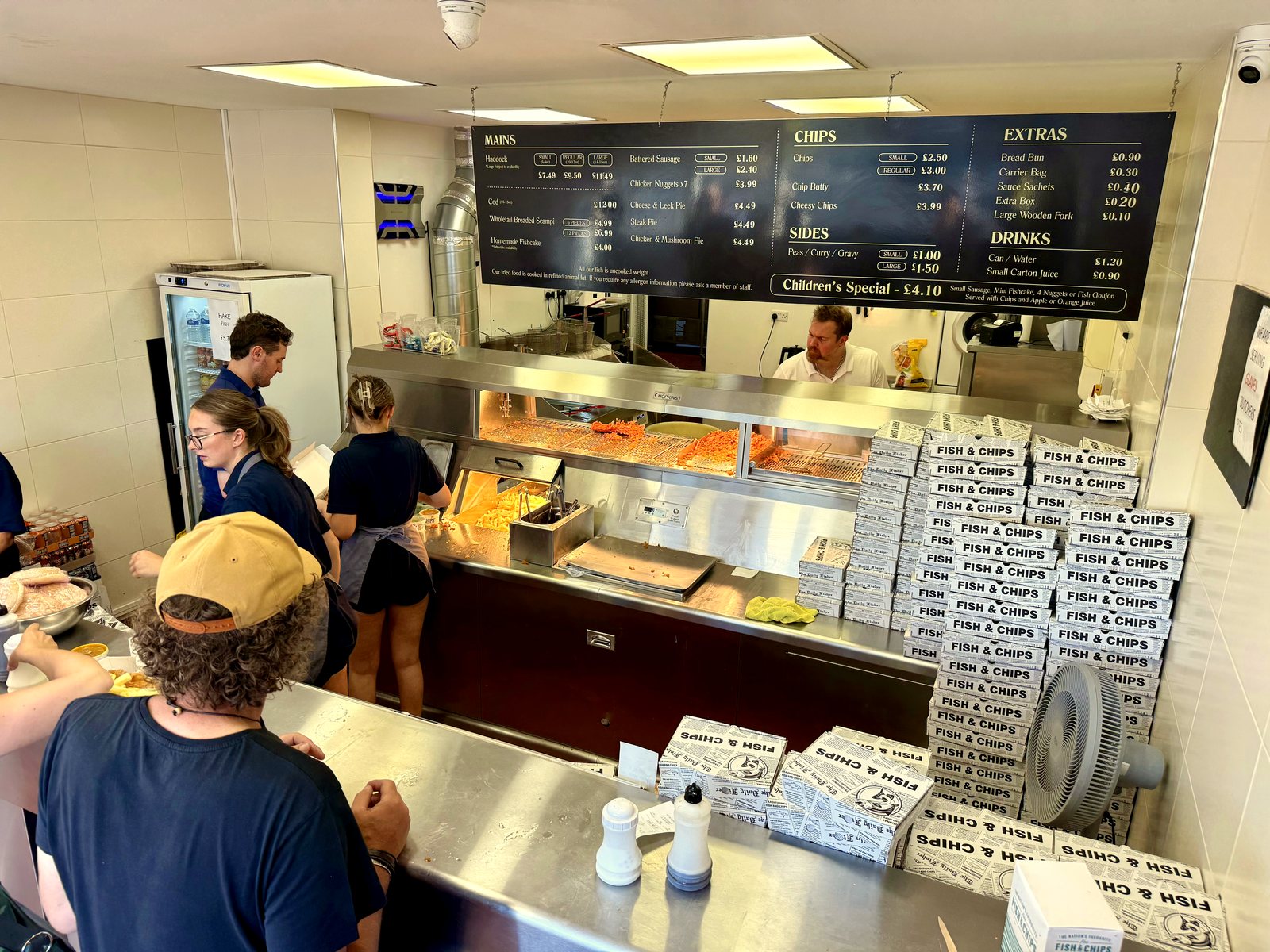 Behind the counter at the fryers